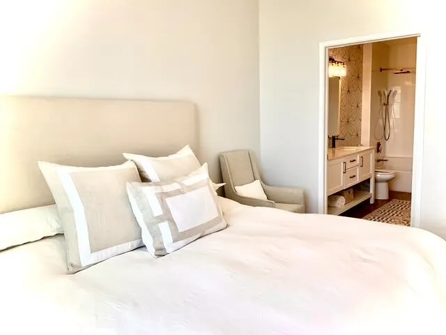 a bedroom with a bed and a large window