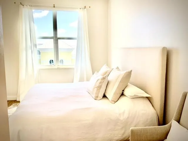 a bedroom with a bed and chair