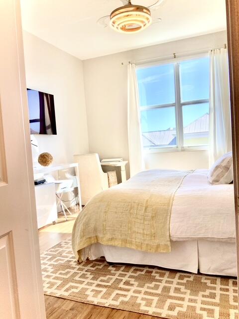 804 East Windward Way, Unit PH 21 Lantana, FL 33462 - Photo 21 of 46 a bedroom with a bed and wooden floor