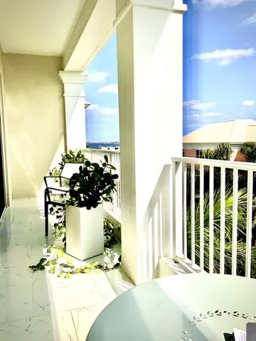 a view of a porch with chairs and backyard