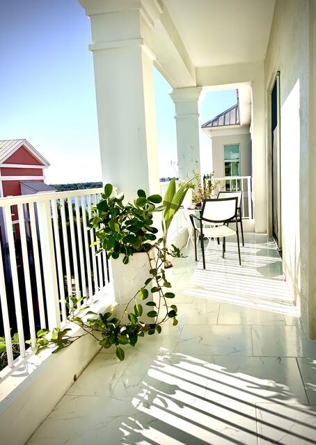 804 East Windward Way, Unit PH 21 Lantana, FL 33462 - Photo 30 of 46 a view of a porch with chairs and backyard