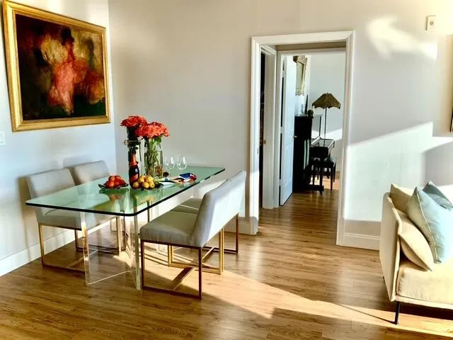 a dining room with furniture and wooden floor