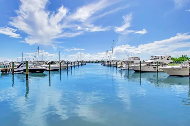 a kitchen that has a lot of cabinets a sink and appliances in it