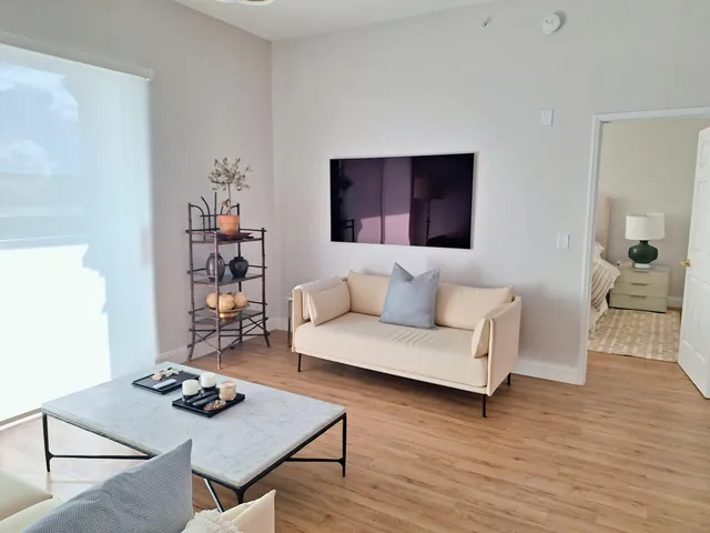 a living room with furniture and a large window
