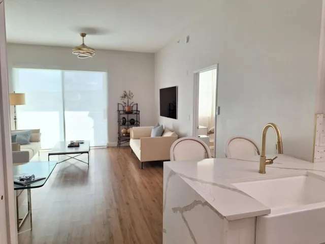 a kitchen with a sink a microwave and cabinets