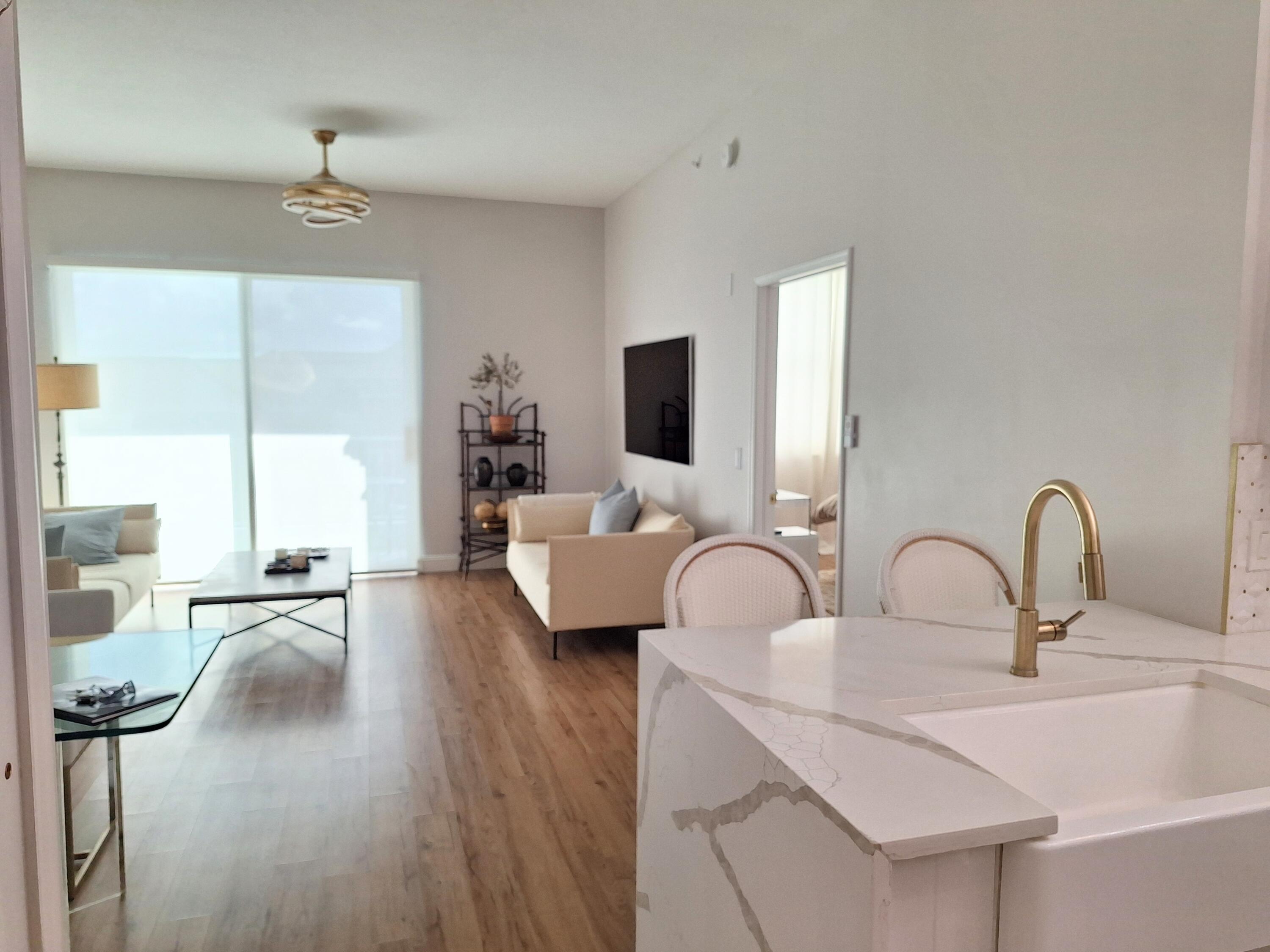 804 East Windward Way, Unit PH 21 Lantana, FL 33462 - Photo 10 of 46 a living room with furniture and a large window