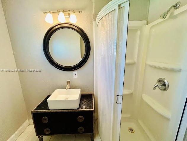3147 Trevino Terrace, Unit 1 Punta Gorda, FL 33983 - Photo 17 of 48 a bathroom with a sink a mirror and shower