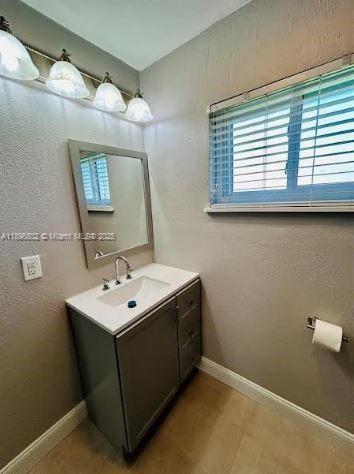 3147 Trevino Terrace, Unit 1 Punta Gorda, FL 33983 - Photo 25 of 48 a bathroom with a sink and a mirror