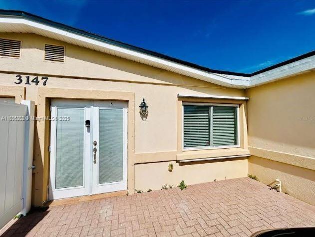 3147 Trevino Terrace, Unit 1 Punta Gorda, FL 33983 - Photo 30 of 48 a view of a backyard with a chair and door