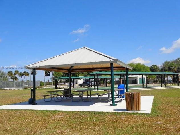 3147 Trevino Terrace, Unit 1 Punta Gorda, FL 33983 - Photo 47 of 48 a view of a patio with a table and chairs under an umbrella