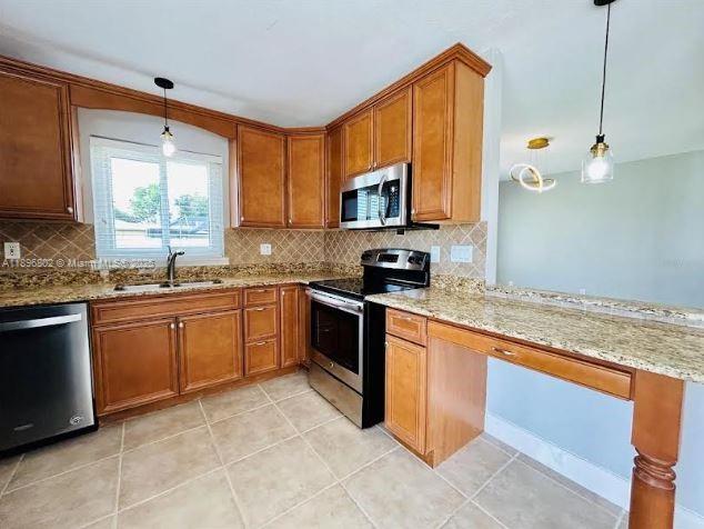 3147 Trevino Terrace, Unit 1 Punta Gorda, FL 33983 - Photo 6 of 48 a kitchen with stainless steel appliances granite countertop a stove sink and cabinets