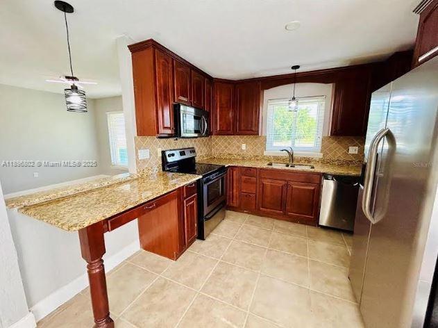 3147 Trevino Terrace, Unit 1 Punta Gorda, FL 33983 - Photo 9 of 48 a kitchen with stainless steel appliances granite countertop a sink stove and refrigerator