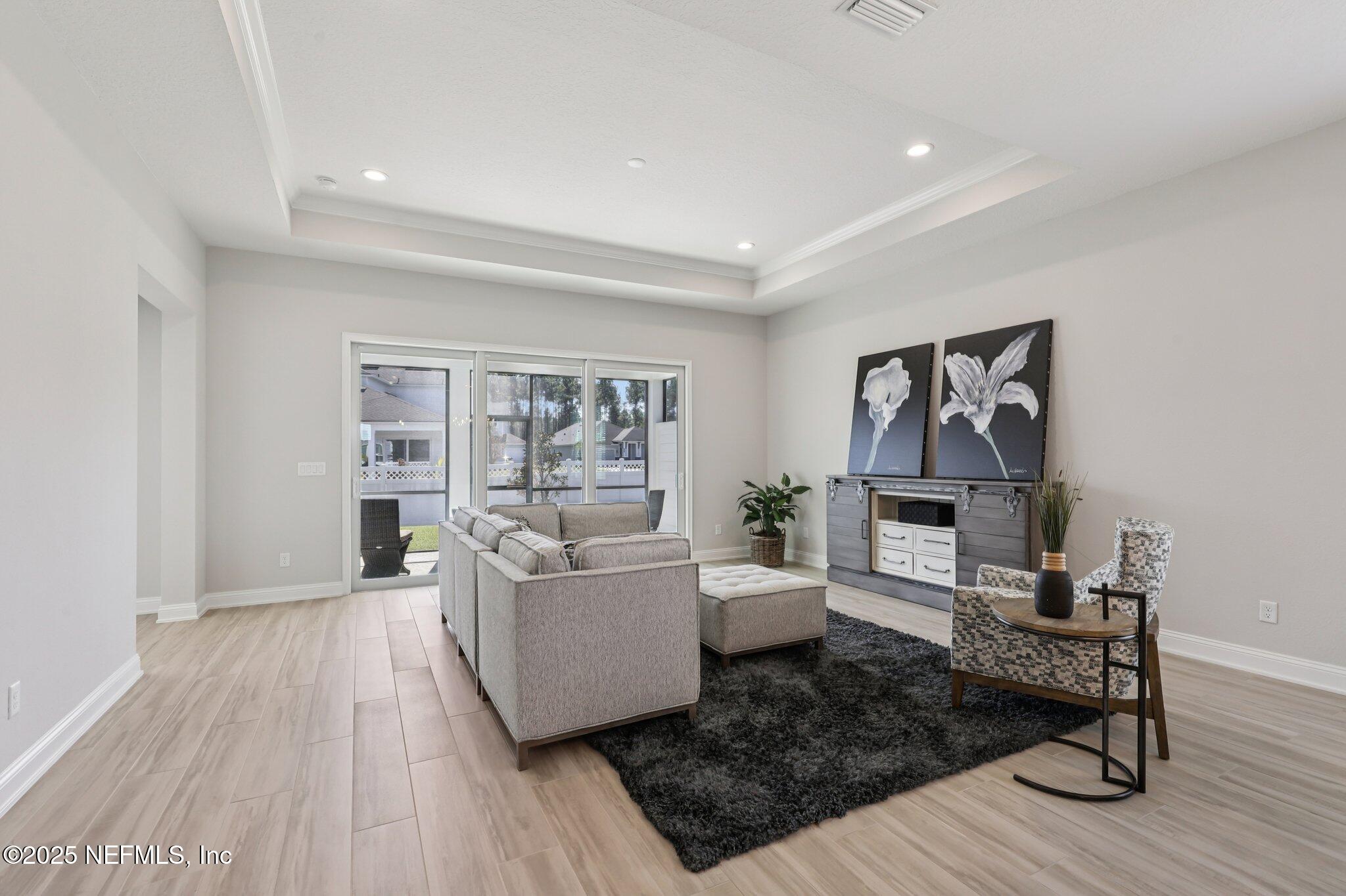 112 Rose Bud Lane St. Augustine, FL 32092 - Photo 19 of 66 a living room with furniture and a wooden floor