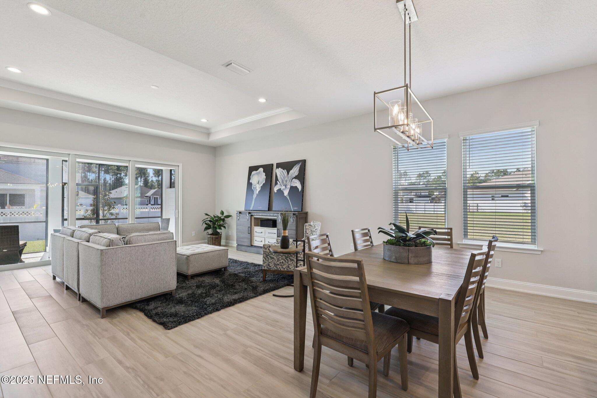 112 Rose Bud Lane St. Augustine, FL 32092 - Photo 26 of 66 a view of a dining room with furniture window and wooden floor