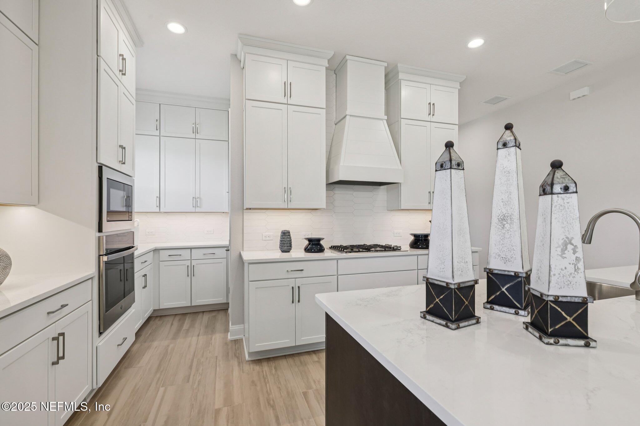112 Rose Bud Lane St. Augustine, FL 32092 - Photo 29 of 66 a kitchen with white cabinets and appliances
