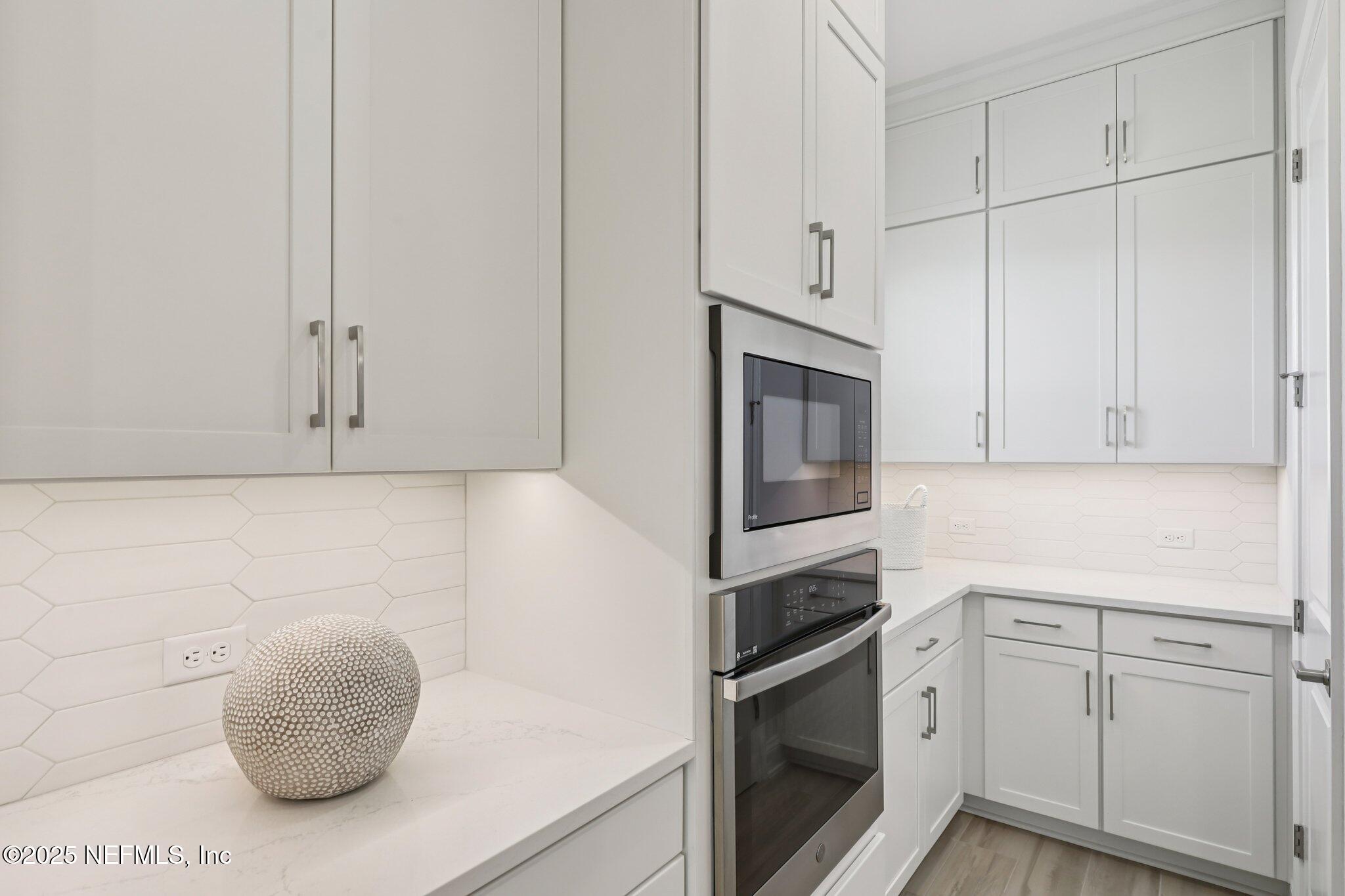 112 Rose Bud Lane St. Augustine, FL 32092 - Photo 31 of 66 a kitchen with granite countertop white cabinets and stainless steel appliances