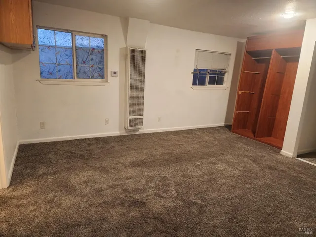 an empty room with closet and stairs