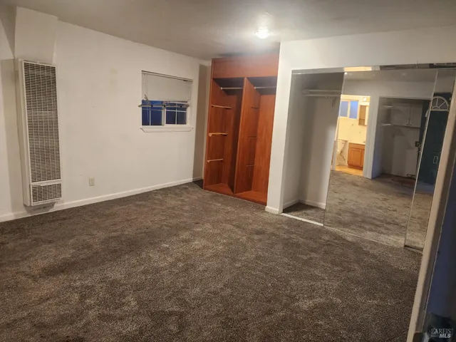 a view of storage and utility room with wooden floor