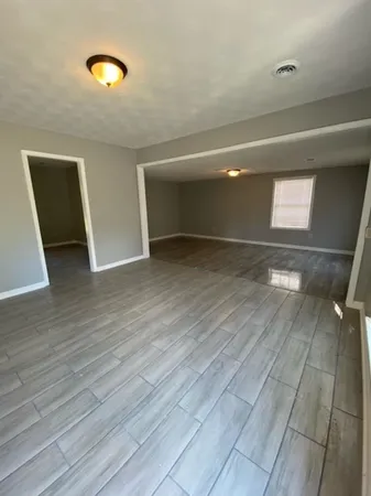 a kitchen with granite countertop a stove and cabinets