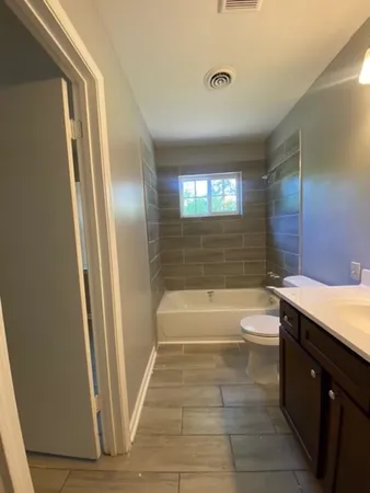 a bathroom with a sink a toilet and tub