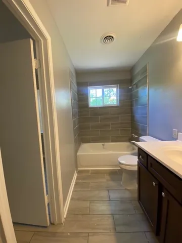 a bathroom with a sink a toilet and tub