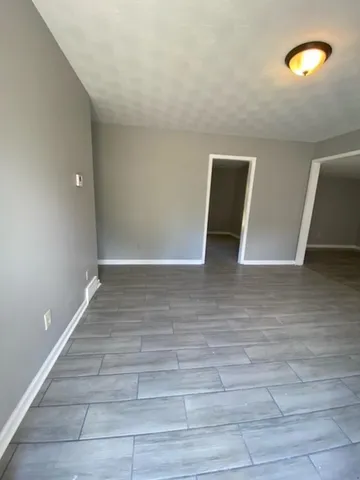 a view of room with stairs and wooden floor