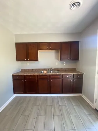 a kitchen with granite countertop a stove and cabinets