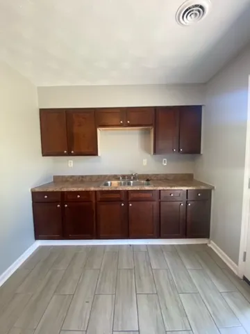 a kitchen with granite countertop a stove and cabinets