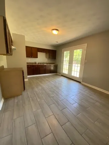 a view of a livingroom with furniture wooden floor and window