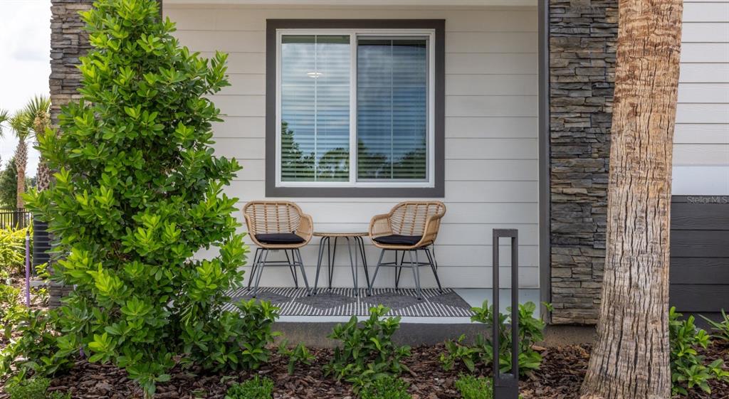 5000 Collina Terrace, Unit TH1 Clermont, FL 34711 - Photo 28 of 28 a view of a patio with table and chairs and potted plants
