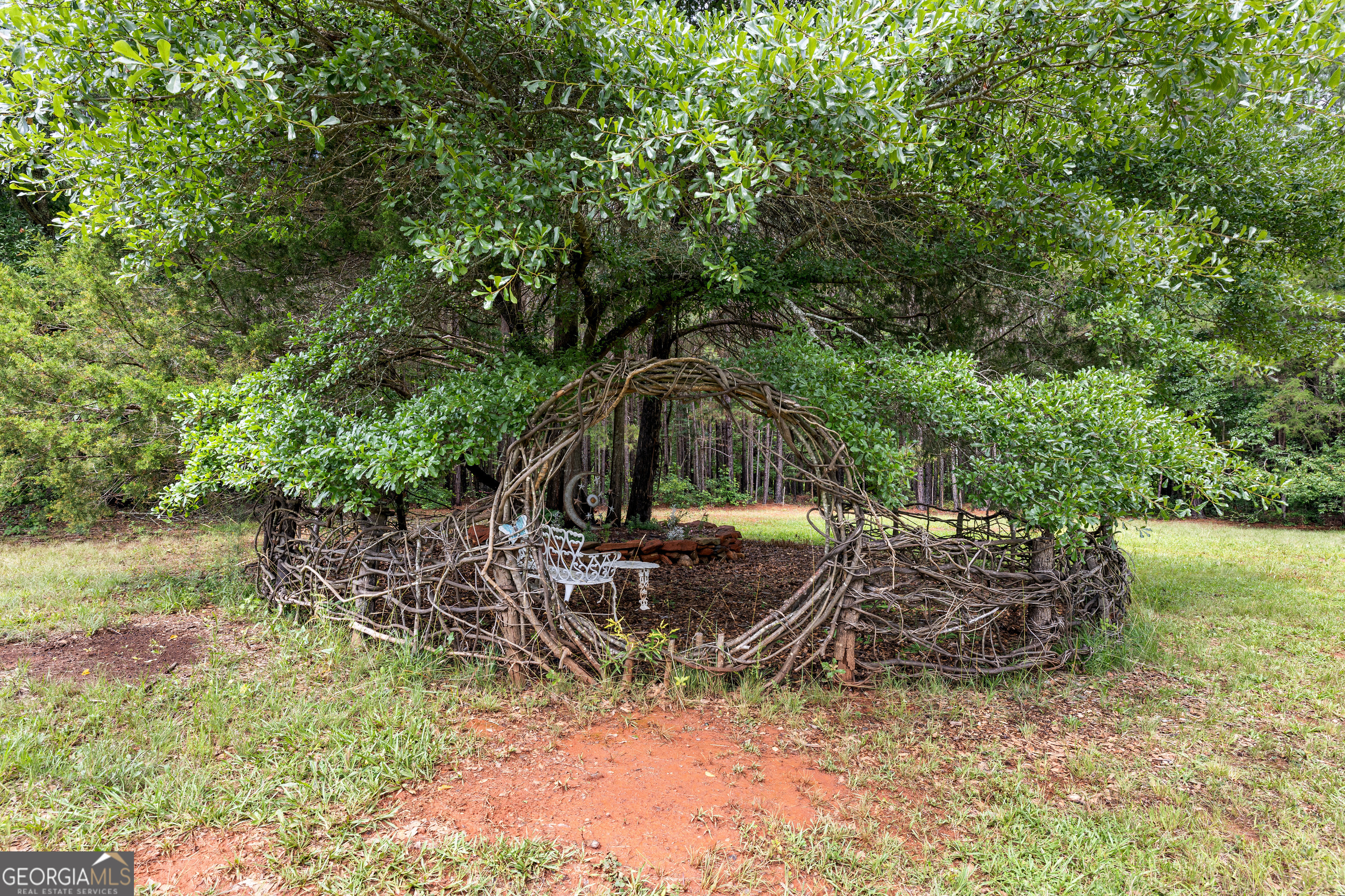 1329 Standing Rock Road Senoia, GA 30276 - Photo 66 of 77 a backyard of a house with table and chairs