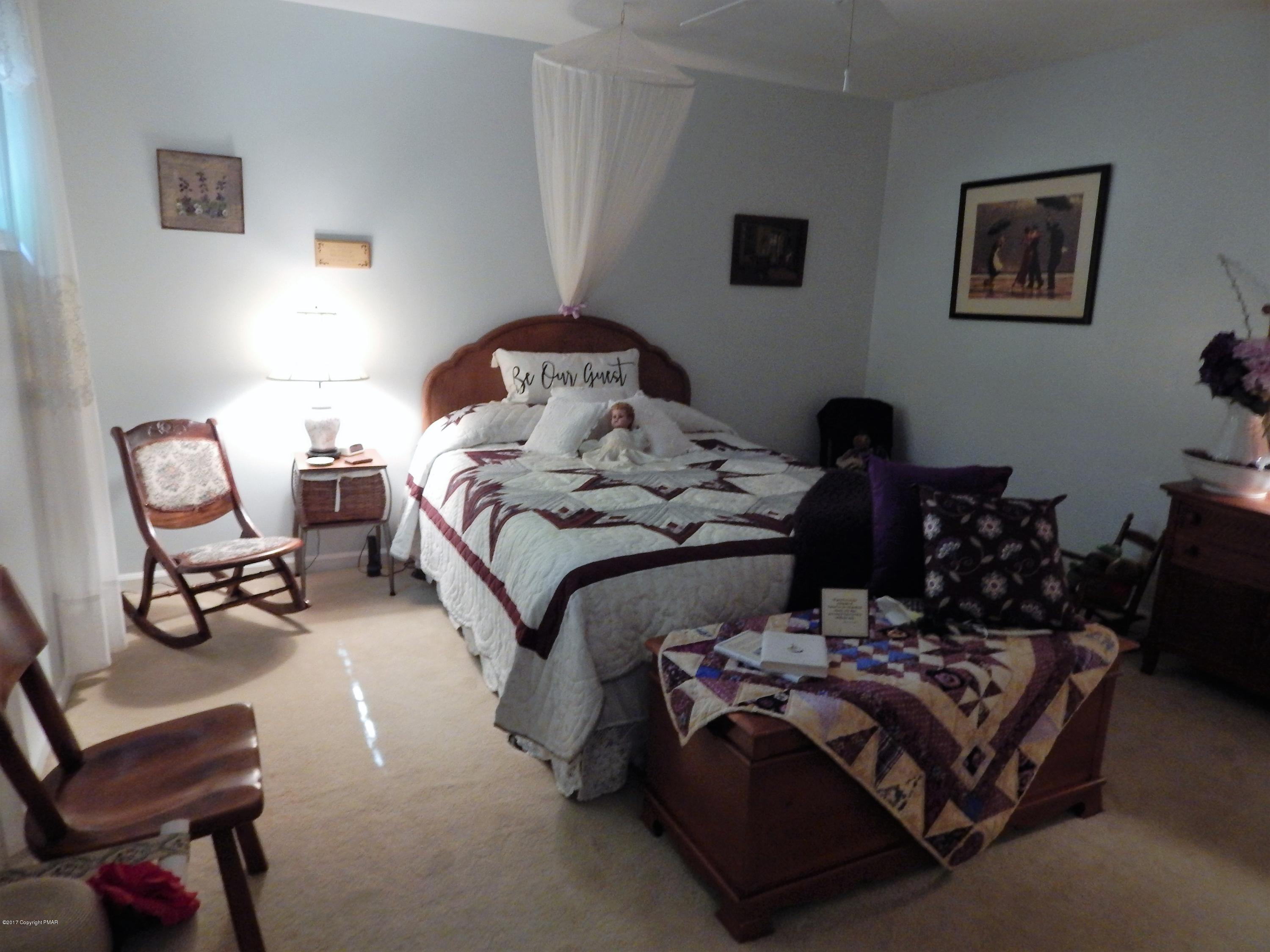 134 Ridge Road Pocono Lake, PA 18347 - Photo 23 of 24 a bedroom with bed and a couch