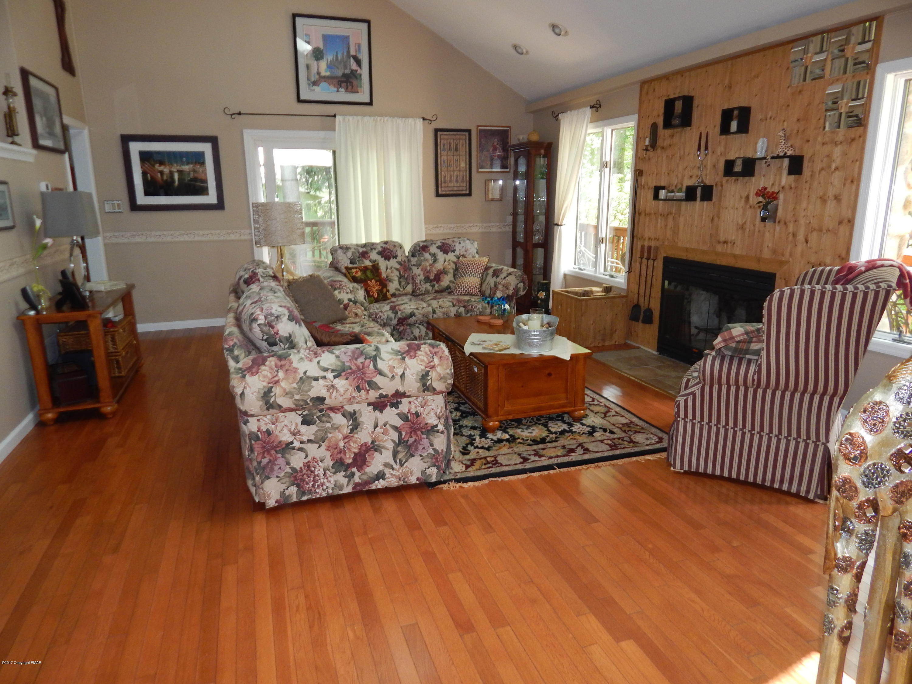 134 Ridge Road Pocono Lake, PA 18347 - Photo 10 of 24 a living room with furniture and a fireplace