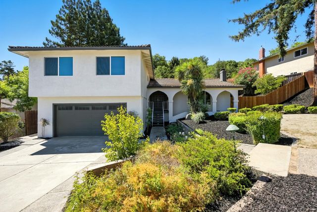 a front view of a house with garden