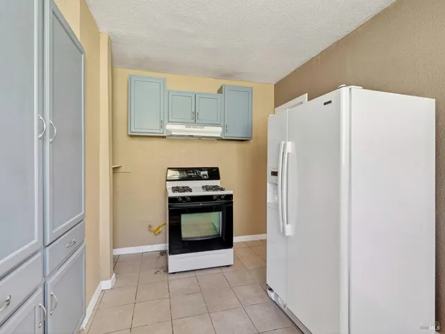 a kitchen with stainless steel appliances a refrigerator and a stove