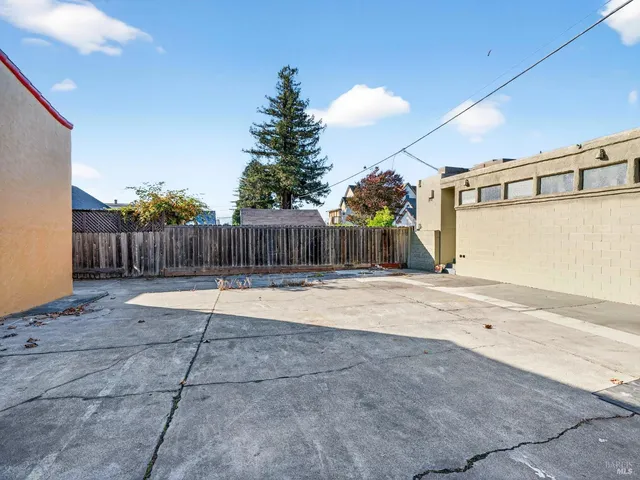a backyard of a house with wooden fence