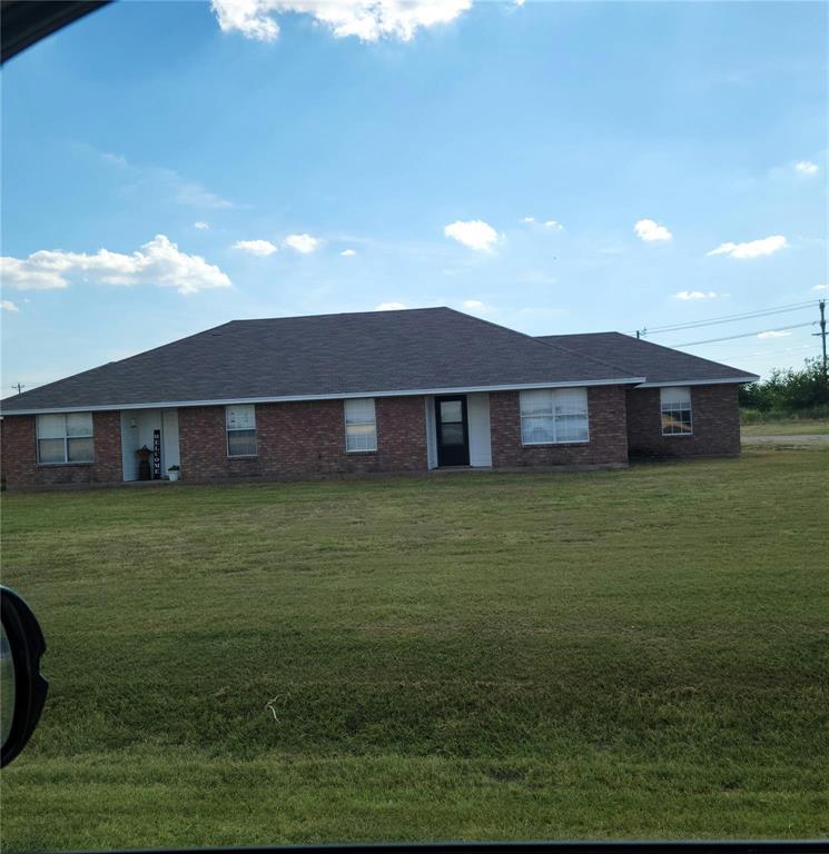 2782 Batey Road, Unit 2780 Collinsville, TX 76233 - Photo 8 of 9 Brick exterior residence featuring a dark shingle roof and multiple windows