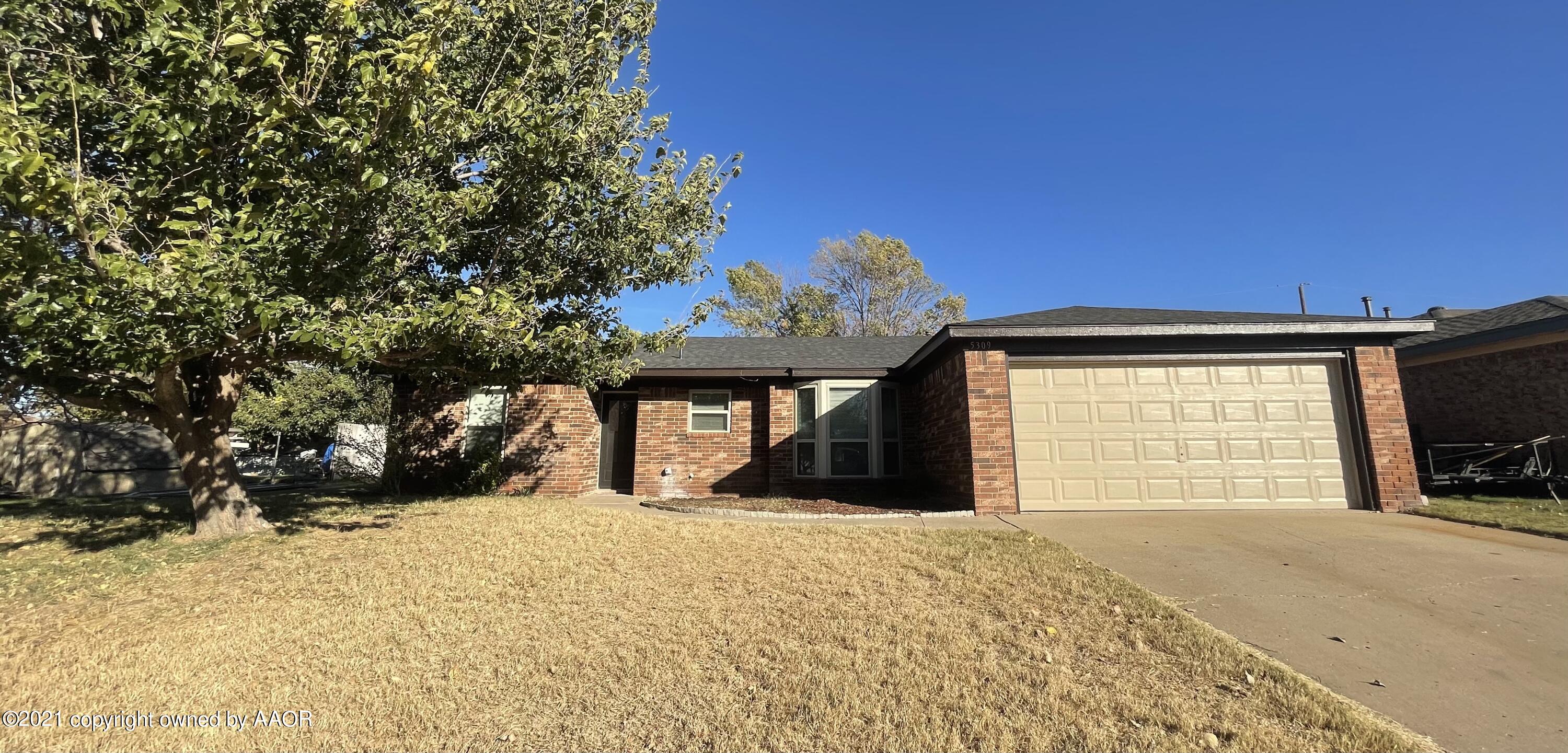 a view of a house with a yard and garage