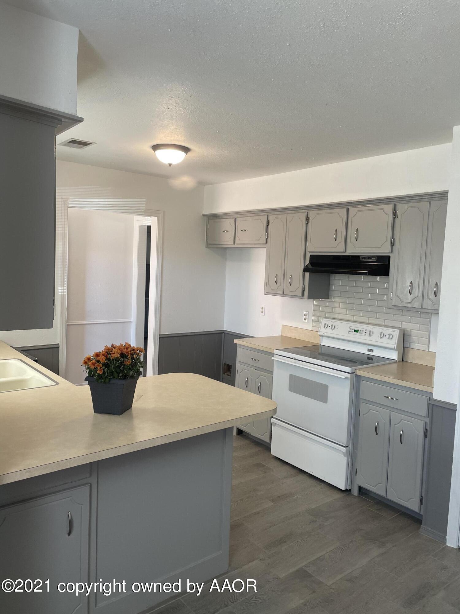 5309 Wheeler Lane Amarillo, TX 79110 - Photo 5 of 20 a kitchen with a sink and cabinets