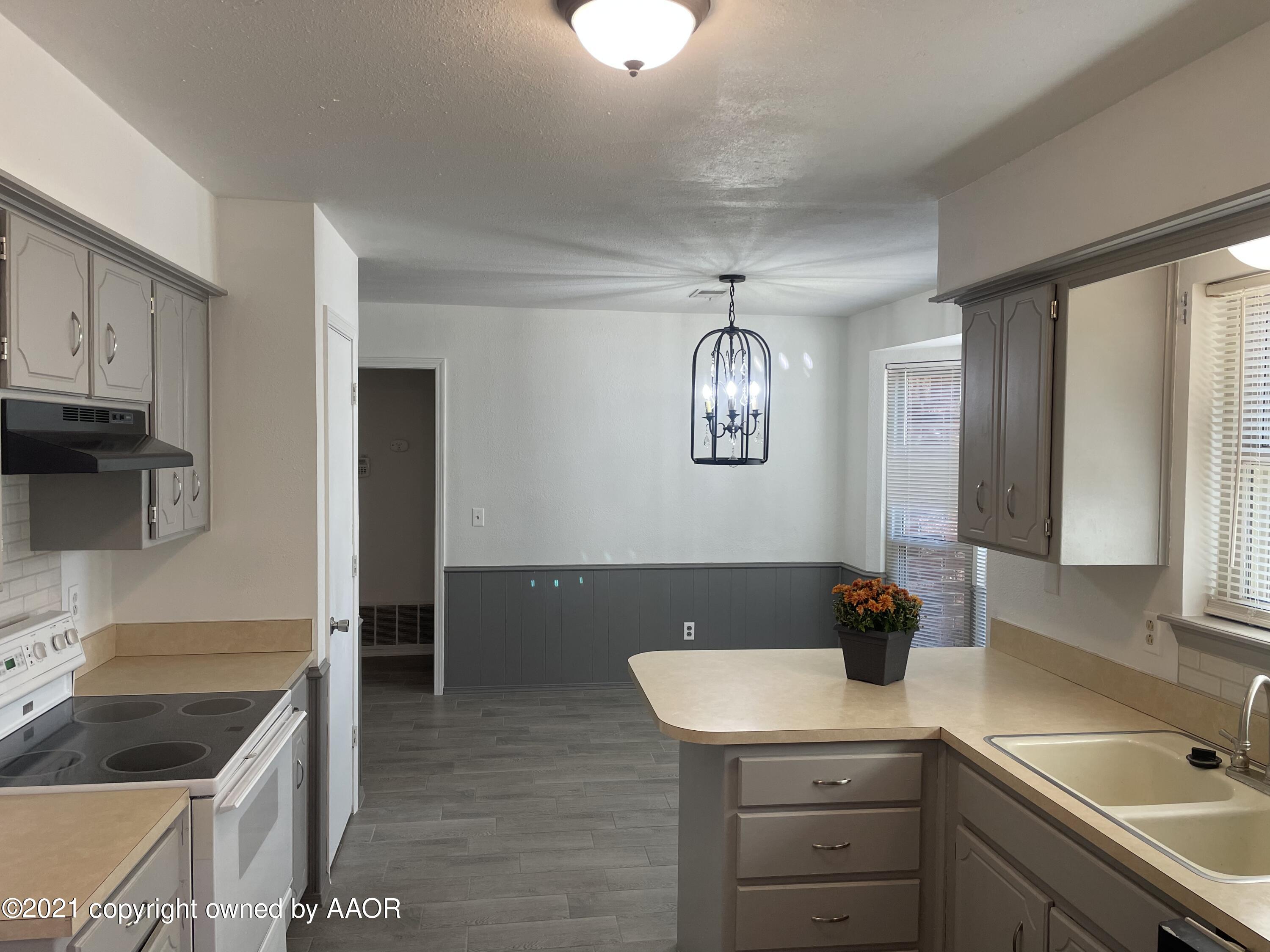 5309 Wheeler Lane Amarillo, TX 79110 - Photo 6 of 20 a kitchen with a sink a stove and cabinets