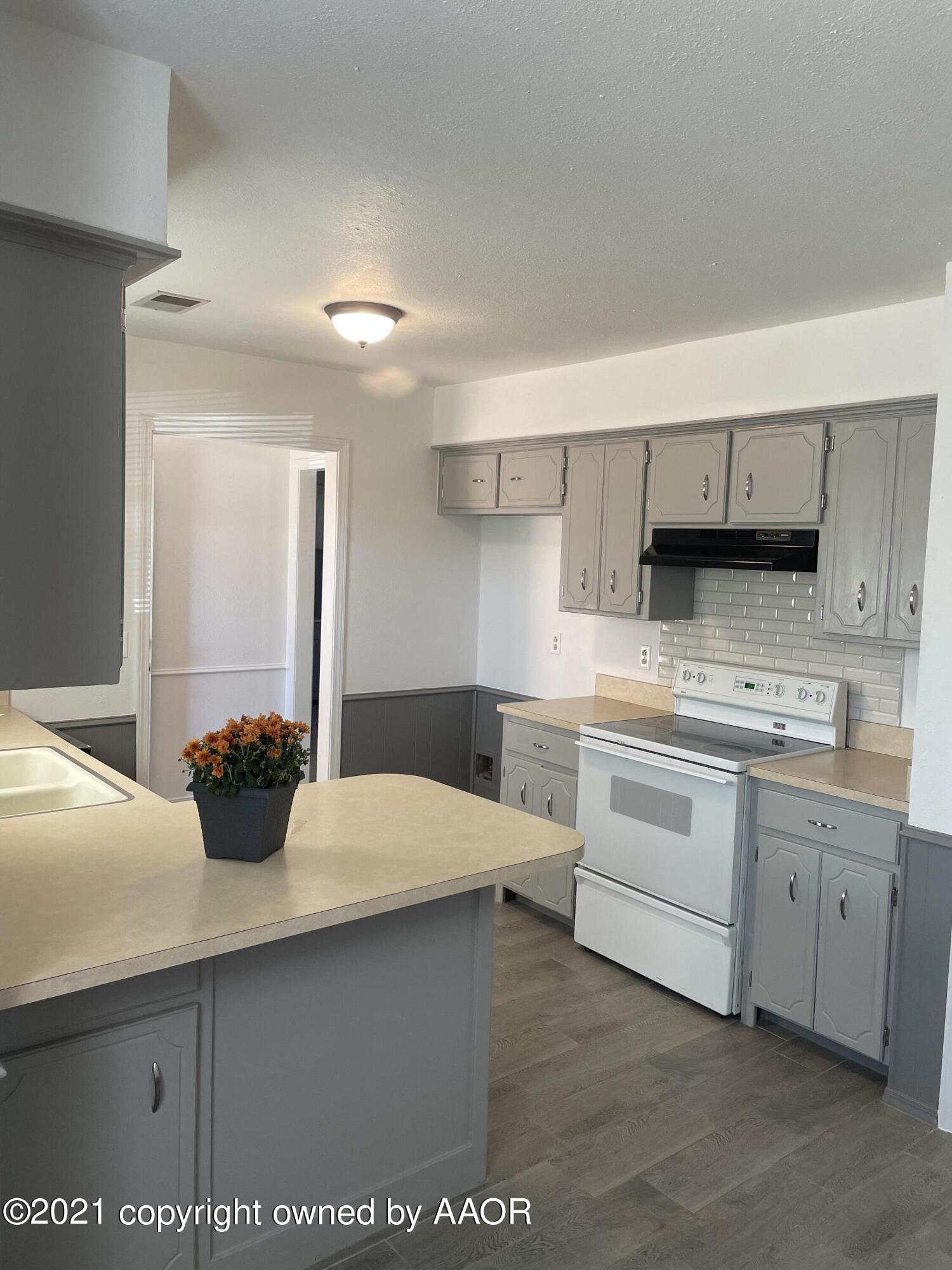 5309 Wheeler Lane Amarillo, TX 79110 - Photo 7 of 20 a kitchen with a sink and cabinets