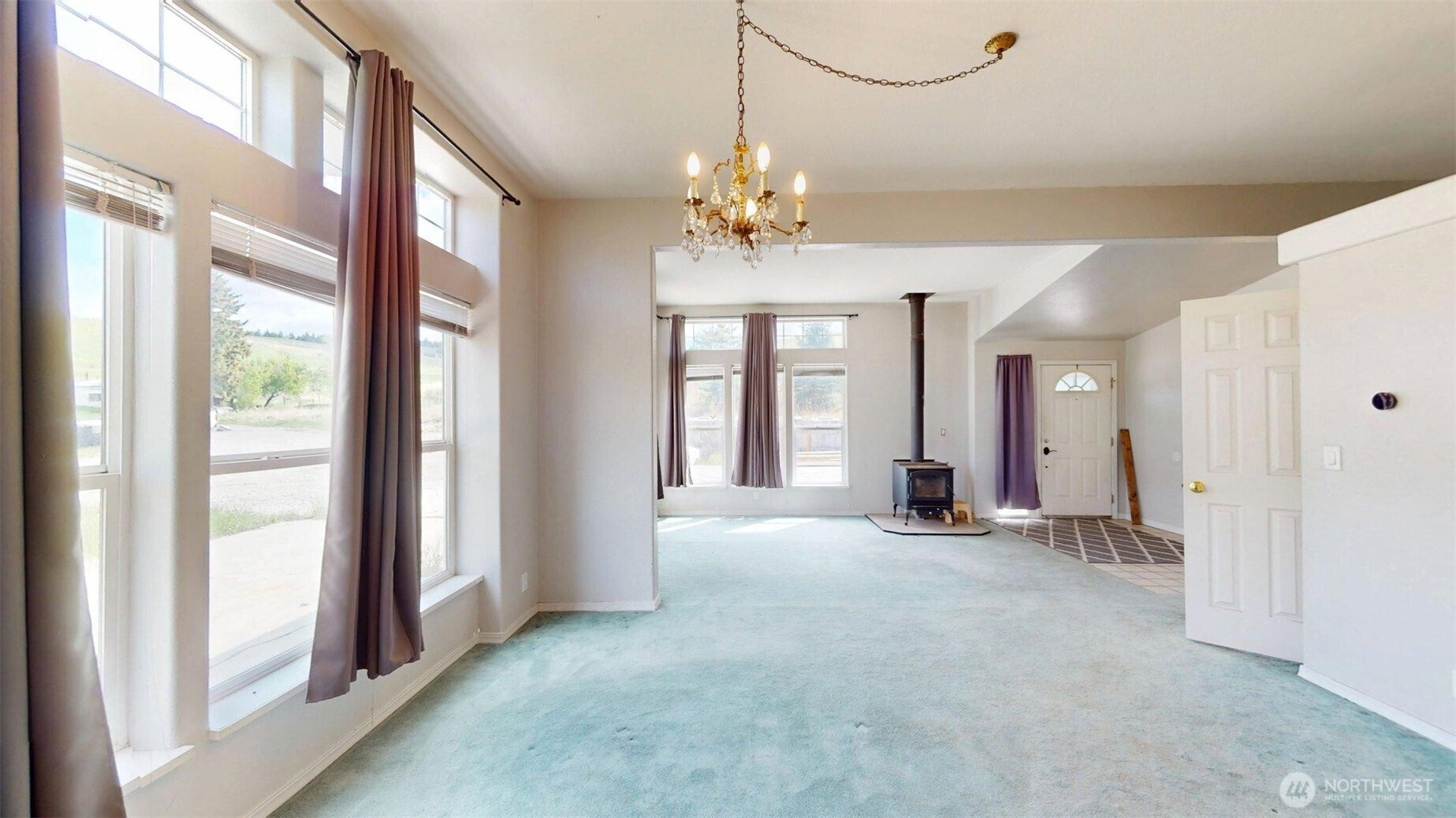 142 Fletcher Road Oroville, WA 98844 - Photo 7 of 26 a view of a livingroom with a chandelier fan and windows