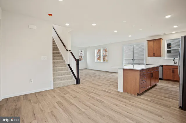 a view of kitchen with wooden floor and electronic appliances