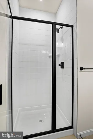 a bathroom with a glass shower door