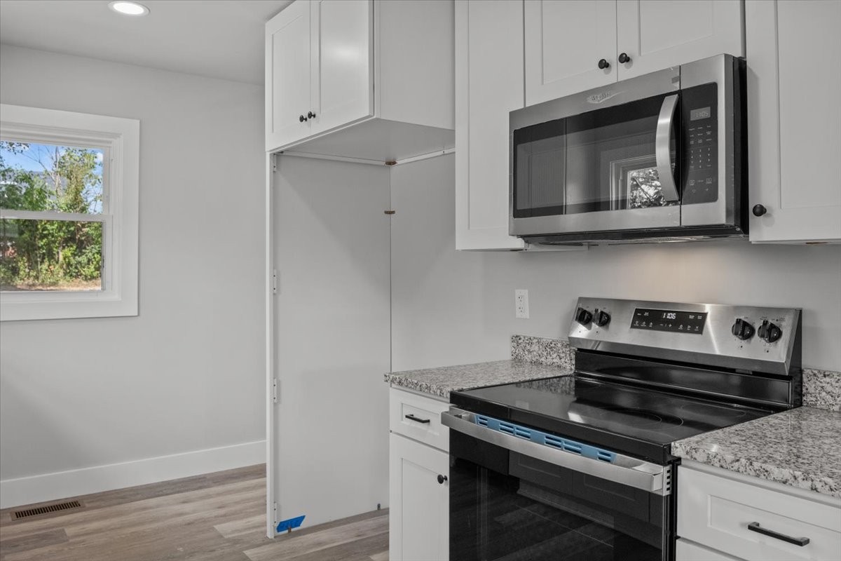 422 High Street Dickson, TN 37055 - Photo 15 of 58 a kitchen with a stove and a microwave