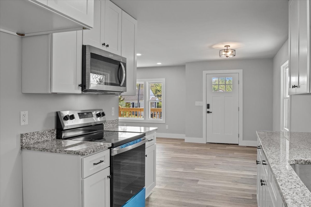 422 High Street Dickson, TN 37055 - Photo 17 of 58 a kitchen with stainless steel appliances granite countertop a sink stove and microwave
