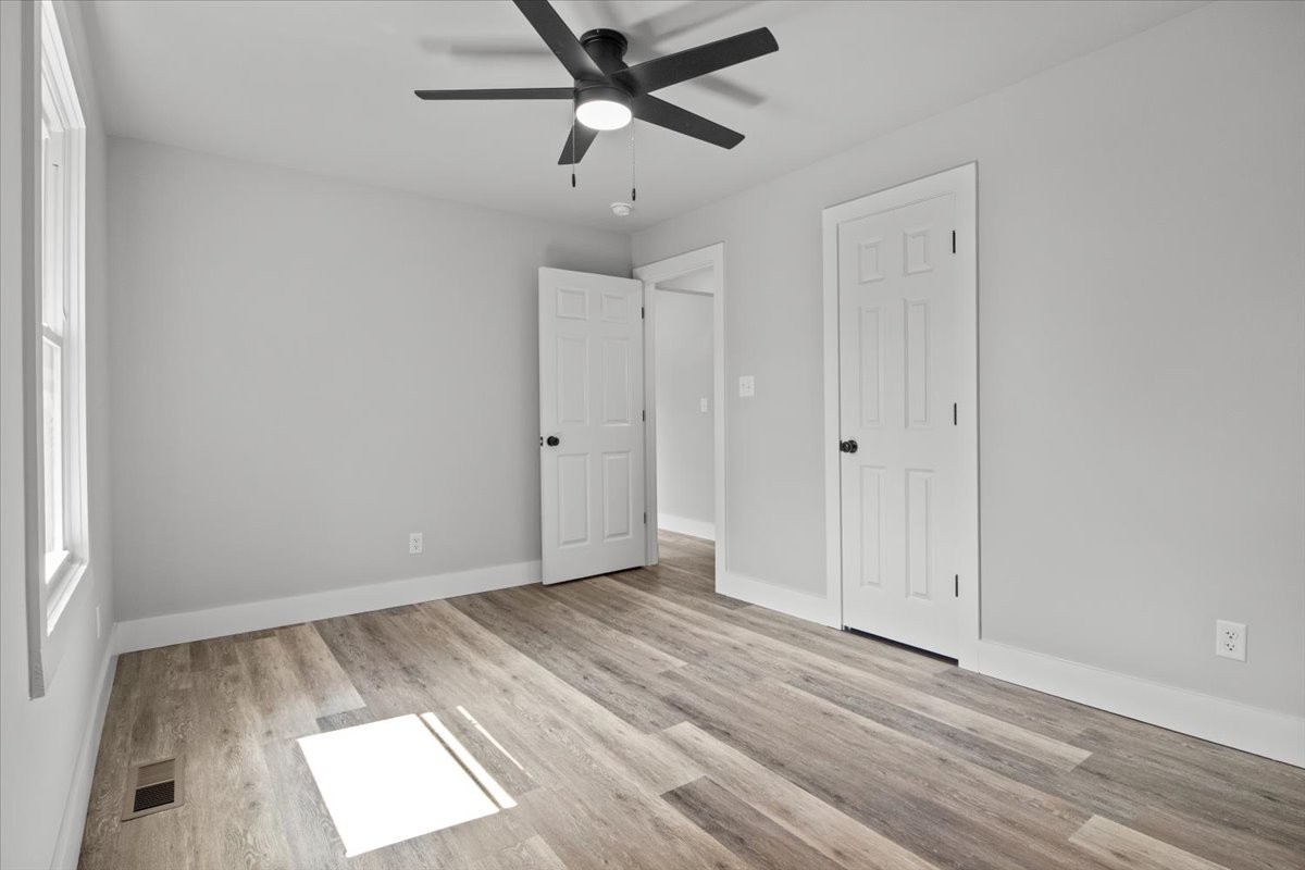 422 High Street Dickson, TN 37055 - Photo 25 of 58 an empty room with wooden floor ceiling fan and windows