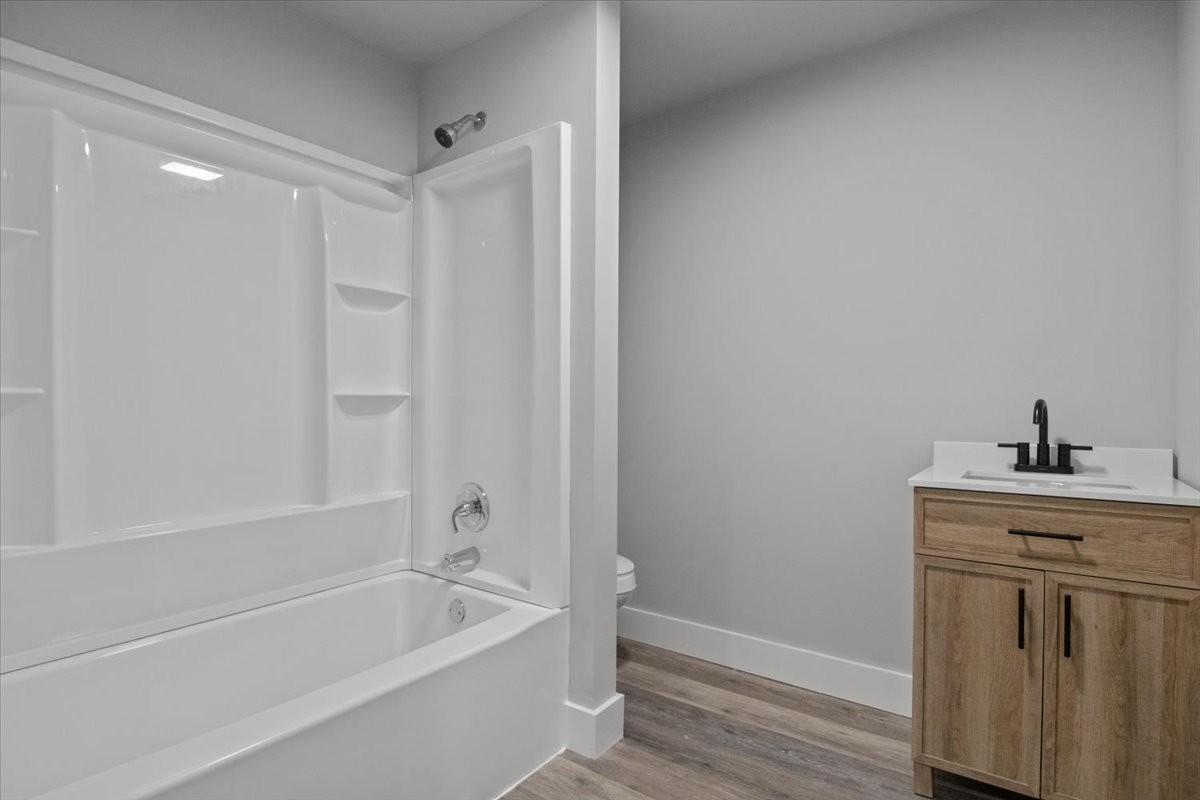 422 High Street Dickson, TN 37055 - Photo 30 of 58 a bathroom with a granite countertop bathtub sink vanity and toilet