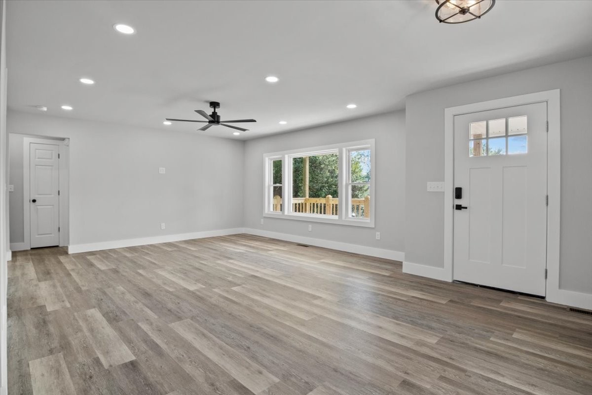 422 High Street Dickson, TN 37055 - Photo 7 of 58 an empty room with wooden floor chandelier and windows