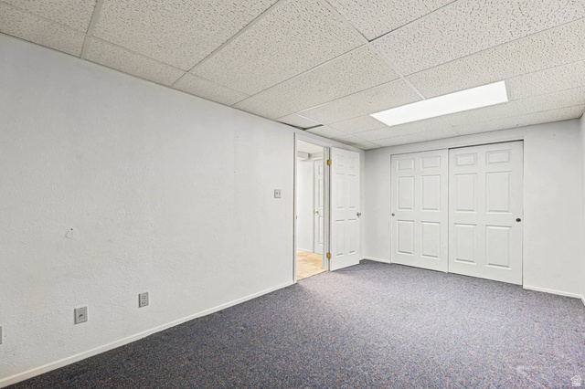 34 Benchmark Village Tooele, UT 84074 - Photo 25 of 35 Finished basement with a drop ceiling and carpet floors